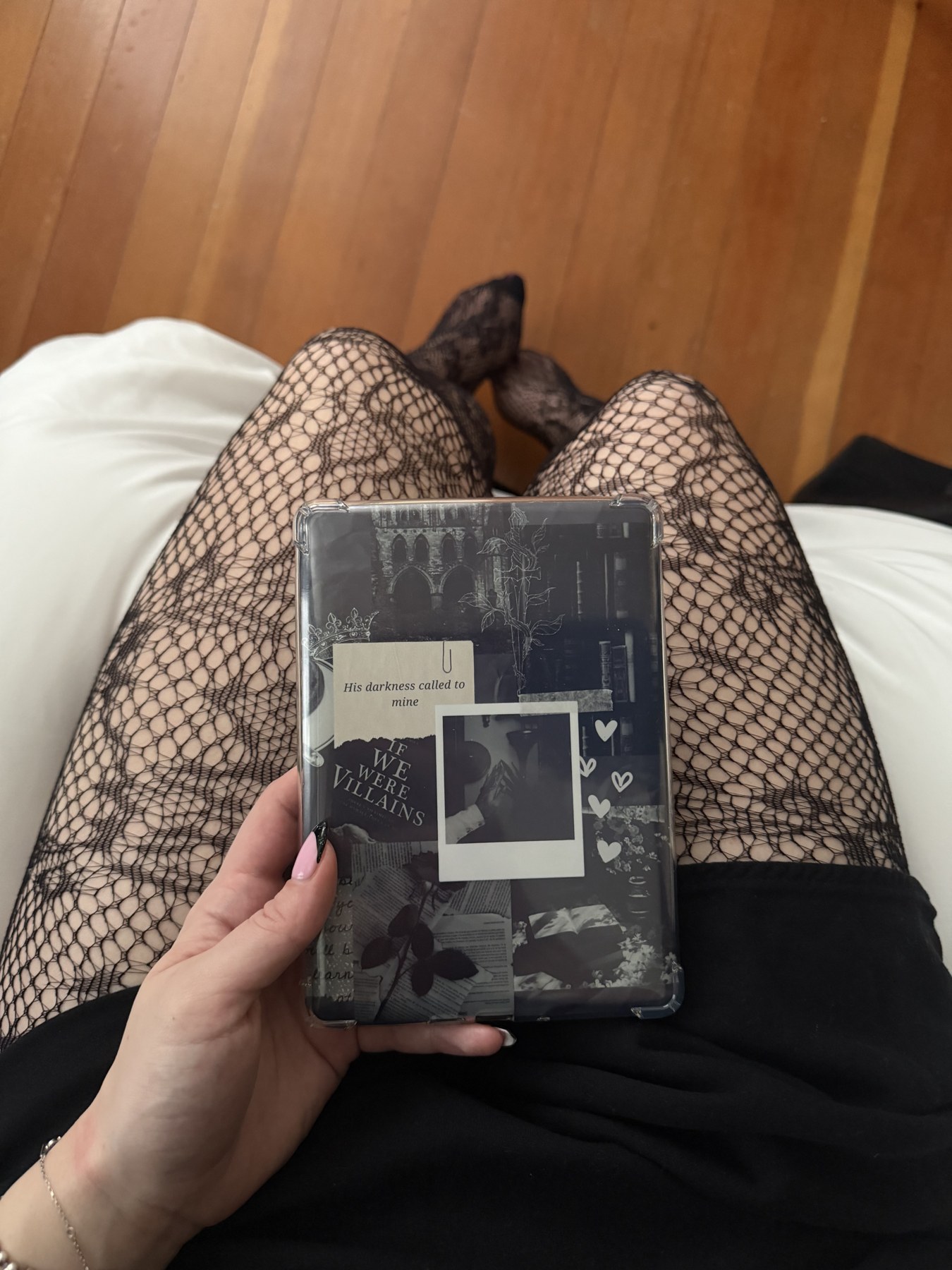 black lace tights and a black outfit coordinated with a collage-decorated kindle case